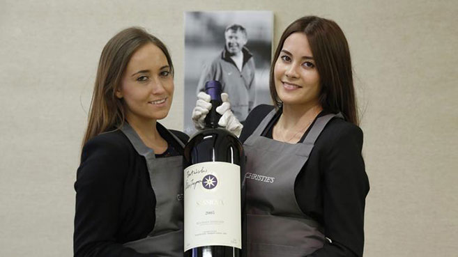 Christie's-employees-pose-with-a-bottle
