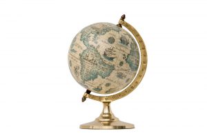 Antique world globe isolated on white background. Studio close-up. Showing North America and South America.